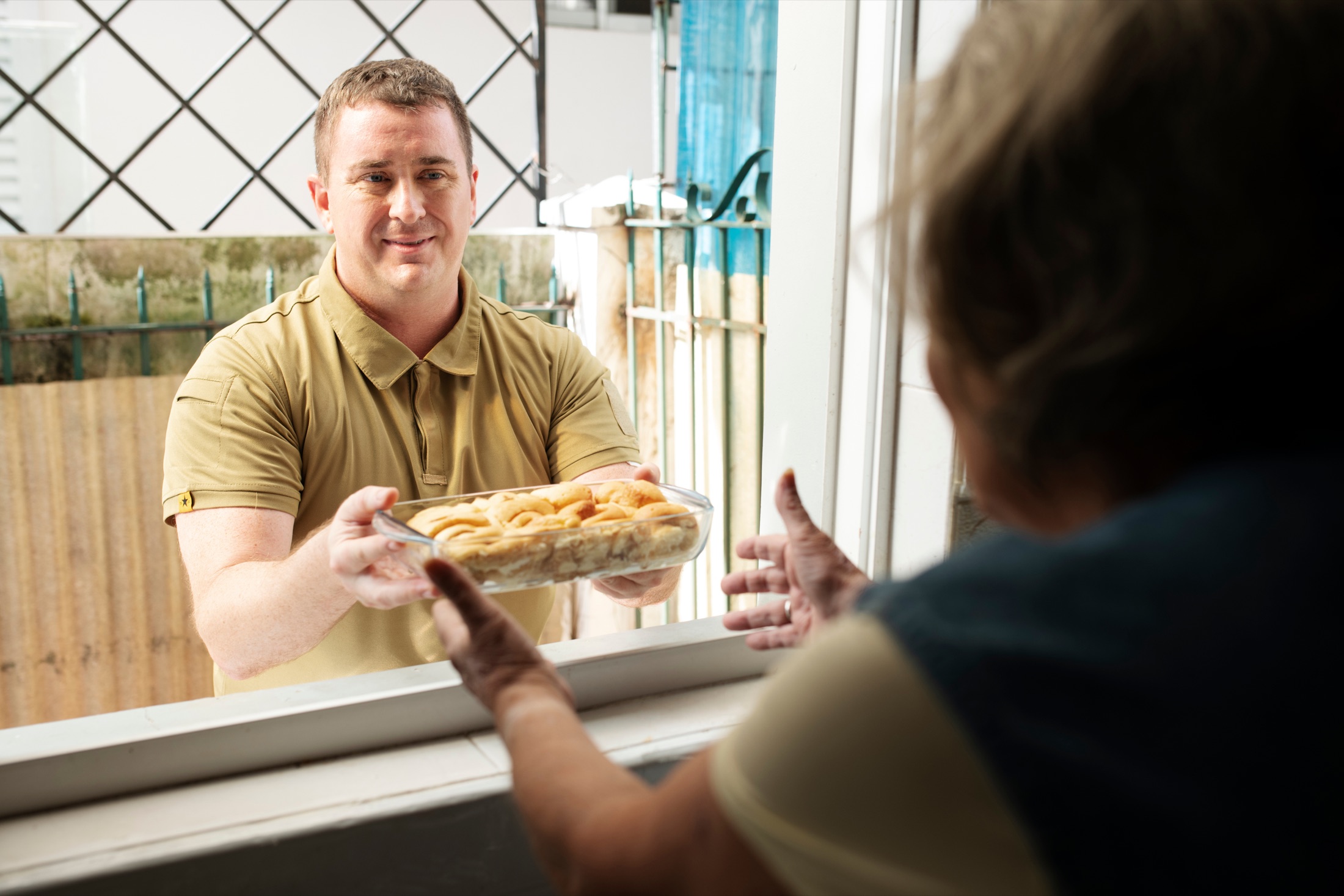 Senior client with a delivered meal.
