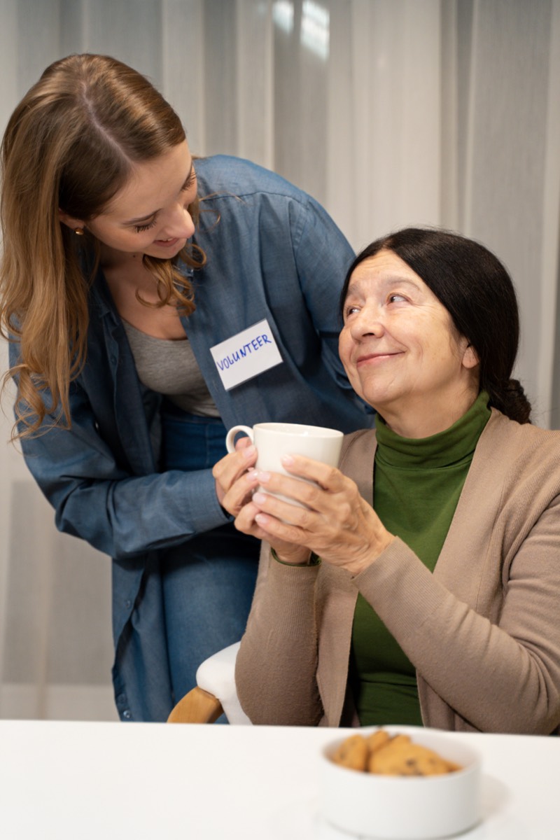 Senior client receiving Meals on Wheels delivery.