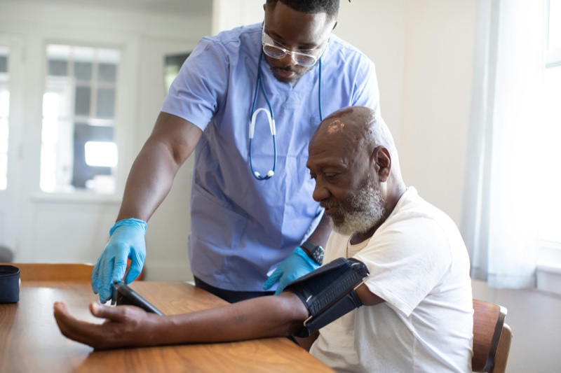 A nurse checking in with a senior client managing a chronic condition at home.