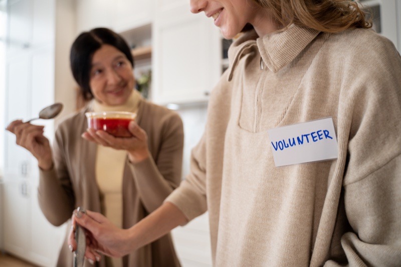 A care coordinator reviewing notes with a senior client at home.