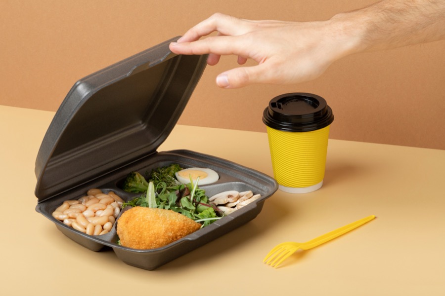A home-delivered meal tray with a hot entree and a coffee cup